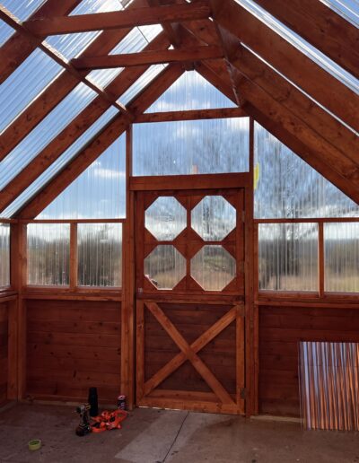 Looking straight at the front door of the inside of a greenhouse.