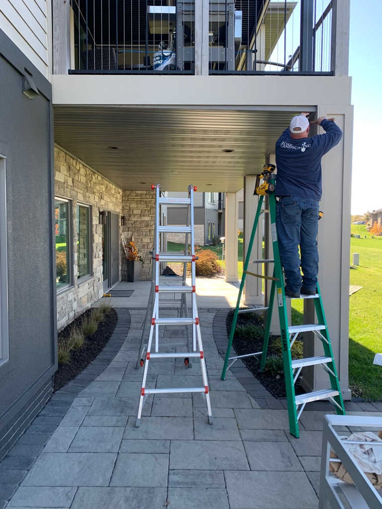 The front and back structure of an enormous metal shed being put up on concrete pad.